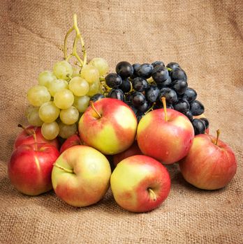 Still life with autumn fruits on burlap background