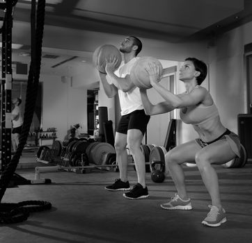 Crossfit ball fitness workout group woman and man at gym