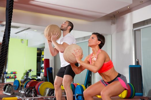 Crossfit ball fitness workout group woman and man at gym