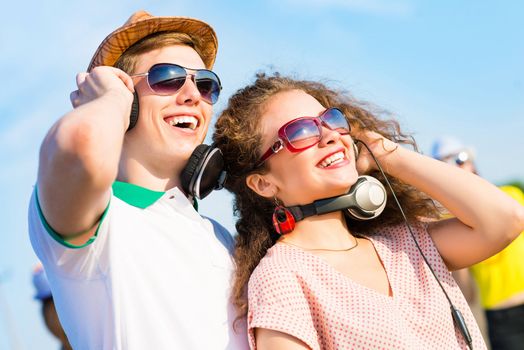 young couple standing on the road, having fun with friends