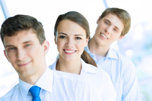 portrait of a young business woman standing in line with colleagues, concept of teamwork