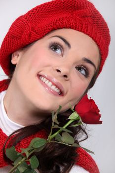 Happy brunette holding a red rose