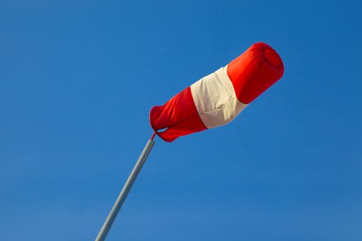 Wind sock against clear blue sky