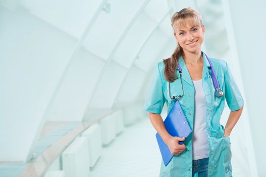 a smiling female doctor holding clipboard