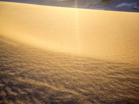 Sand glows with last rays of sunlight Death Valley National Park