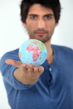 Man holding the world in the palm of his hand