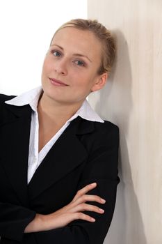 Blond businesswoman casually leaning