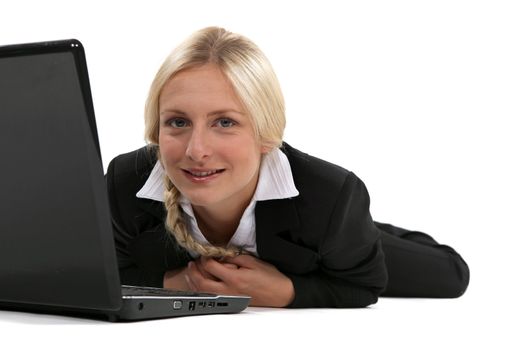 Blond woman laying with laptop