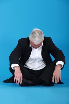 Grey-haired businessman taking nap