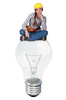 Laborer sitting on light bulb