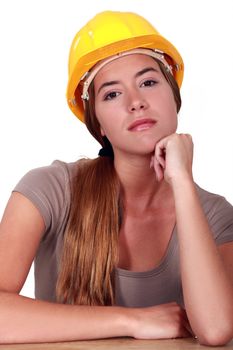 A pensive female manual worker.