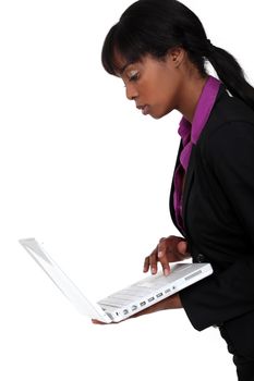 Black woman holding laptop