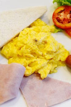 Scrambled eggs with bread in dish