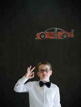 All ok or okay sign boy dressed up as business man with Nascar racing fan car on blackboard background