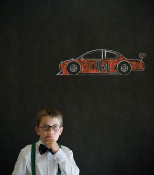 Thinking boy dressed up as business man with Nascar racing fan car on blackboard background