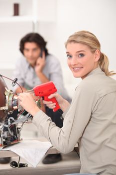 A woman fixing a TV.