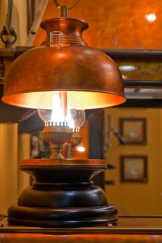 Old kerosene lamp with copper shade