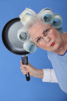 Angry old lady threatening to use frying pan