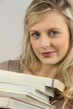 Woman with a stack of books