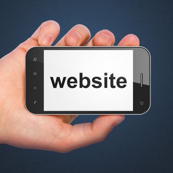 SEO web development concept: hand holding smartphone with word Website on display. Generic mobile smart phone in hand on Dark Blue background.