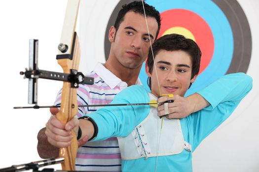 Teenage boy archery lesson