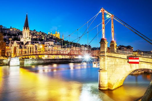 night view from St Georges footbridge in Lyon city with Fourviere cathedral, France