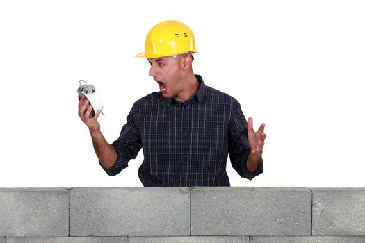 Entrepreneur screaming in front of an alarm clock