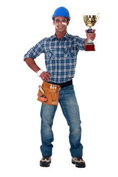 Happy builder holding trophy