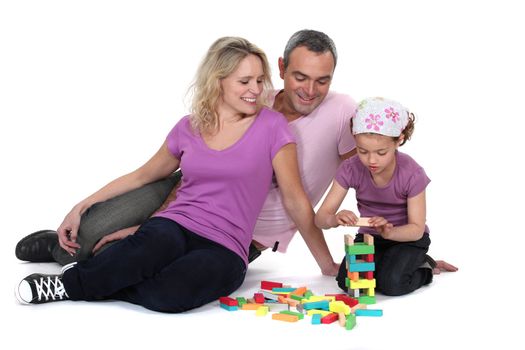 Parents and child playing with construction blocks