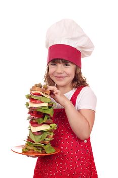 happy little girl cook hold tall sandwich