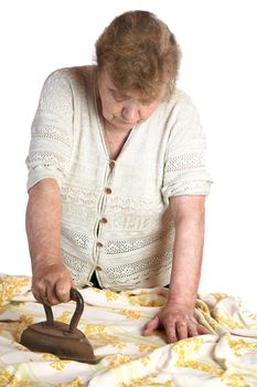 The grandmother irons  fabric the ancient iron on a white background