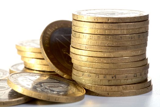 Pile of yellow metal coins on a textural background