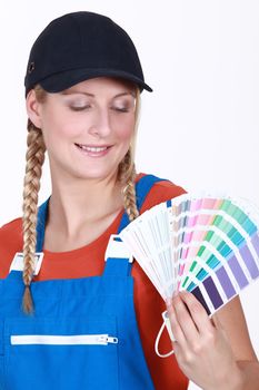 Woman choosing which color paint to use