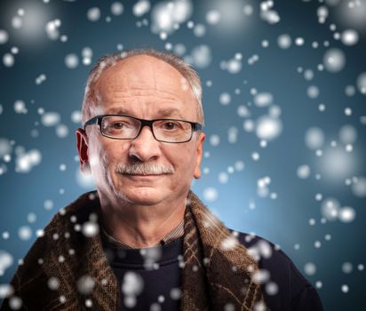 x-mas, winter, happiness concept - smiling  elderly man looks skeptically