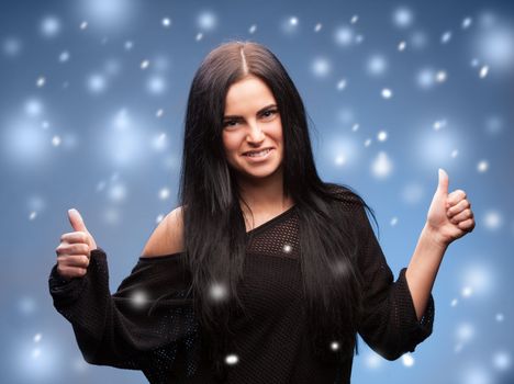 christmas, x-mas, winter, happiness concept - beautiful woman showing thumbs up