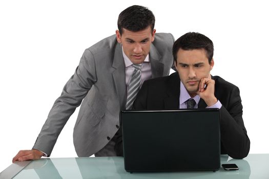 Business associates reading a distressing e-mail