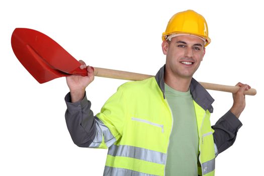 Tradesman carrying a spade on his shoulders