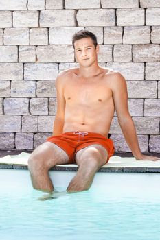 An image of a handsame man relaxing at the pool