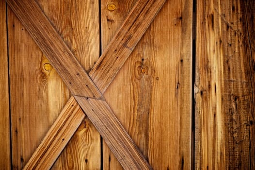 Barn door details with weathered and worn wood planks that include rusty nails and knots