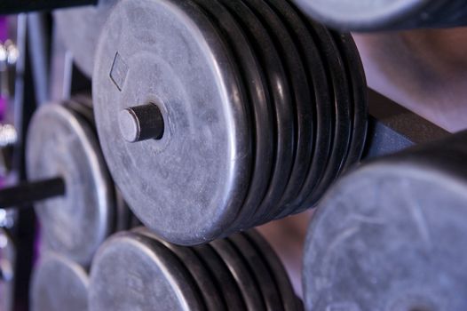 Image of a full weight rack for free weights at a commercial gym