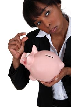 Businesswoman holding a piggy bank.