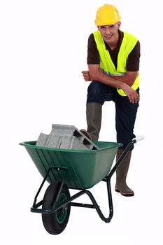 Labourer transporting concrete blocks