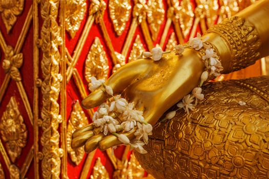 Buddha statue hand with flowers. Wat Phra That Doi Suthep, Chiang Mai, Thailand