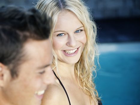 A beautiful blonde woman in the blue pool