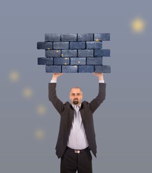 Businessman holding a large piece of a brick wall, flag of Alaska, isolated on national flag