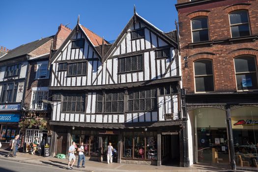 York, United Kingdom - September 22, 2013: View at York's oldest Tudor building called Sir Thomas Herbert’s House at 14 Pavement in York, UK, with pedestrians passing by.