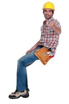 A construction worker making a hand sign.