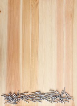 Metal pop rivets on a woodgrain background