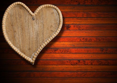 Handmade wooden heart hanging on brown wooden background
