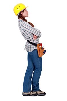 A female construction worker looking away.